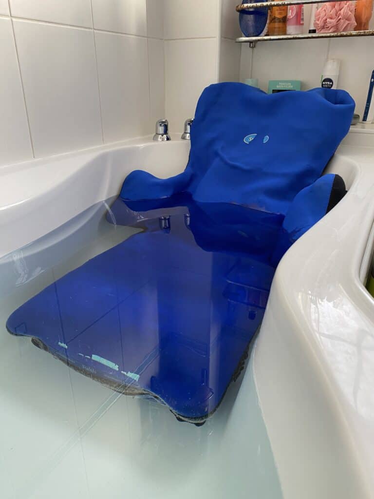 The Aqua Liberty mouldable bath support shown in situ in a bath with water