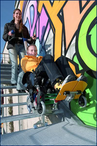 disabled child in wheelchair uses stairclimber to navigate steps