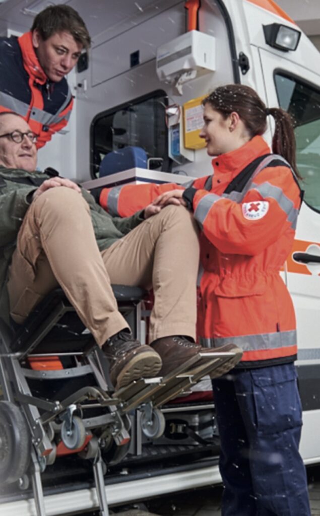 Paramedics use a C-Max stairclimber to safely transfer a patient into an ambulance