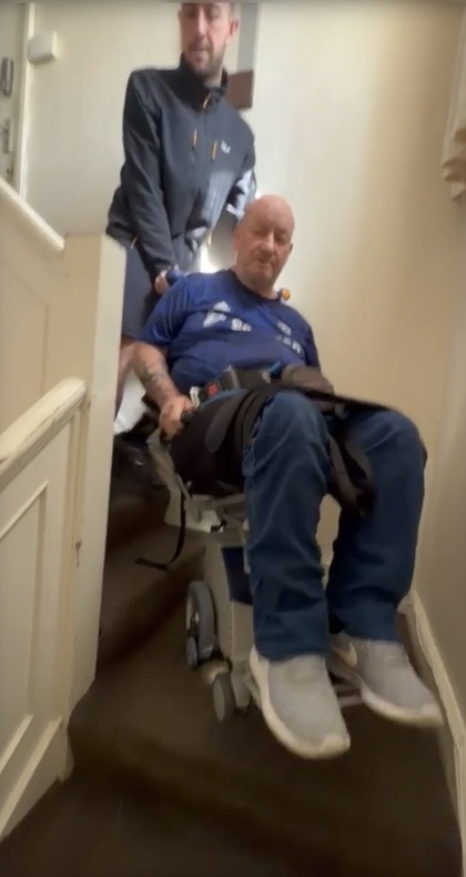 disabled man navigates turn on stairs using a stairclimber